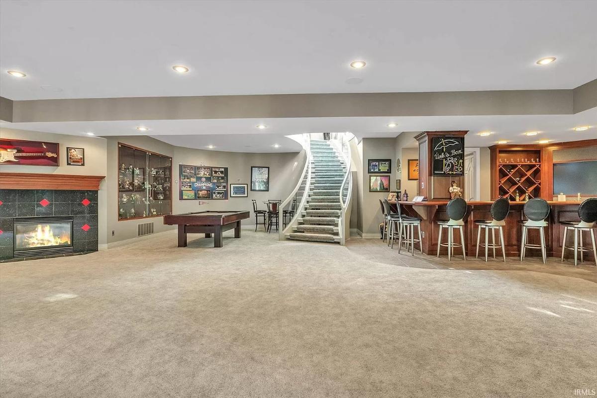 Recreational room with a billiards table and a bar.
