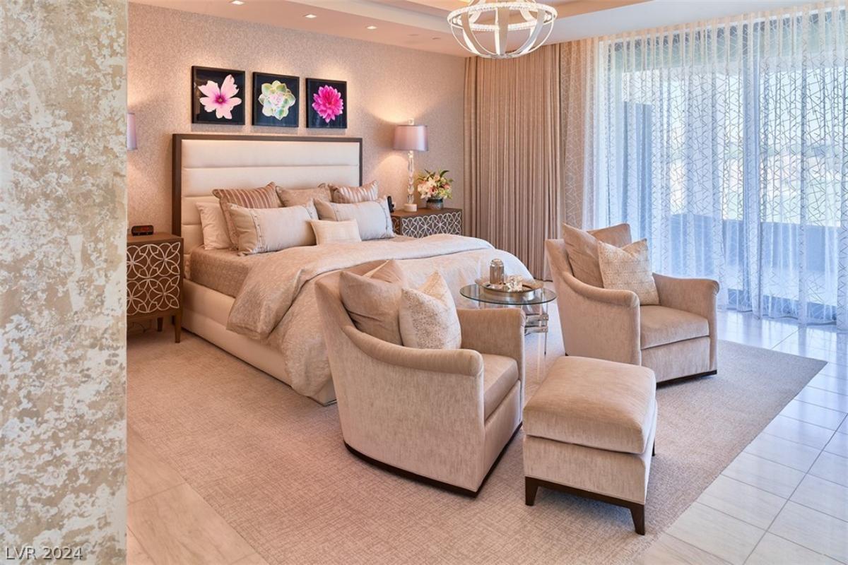 Bedroom with a large bed and tile flooring.