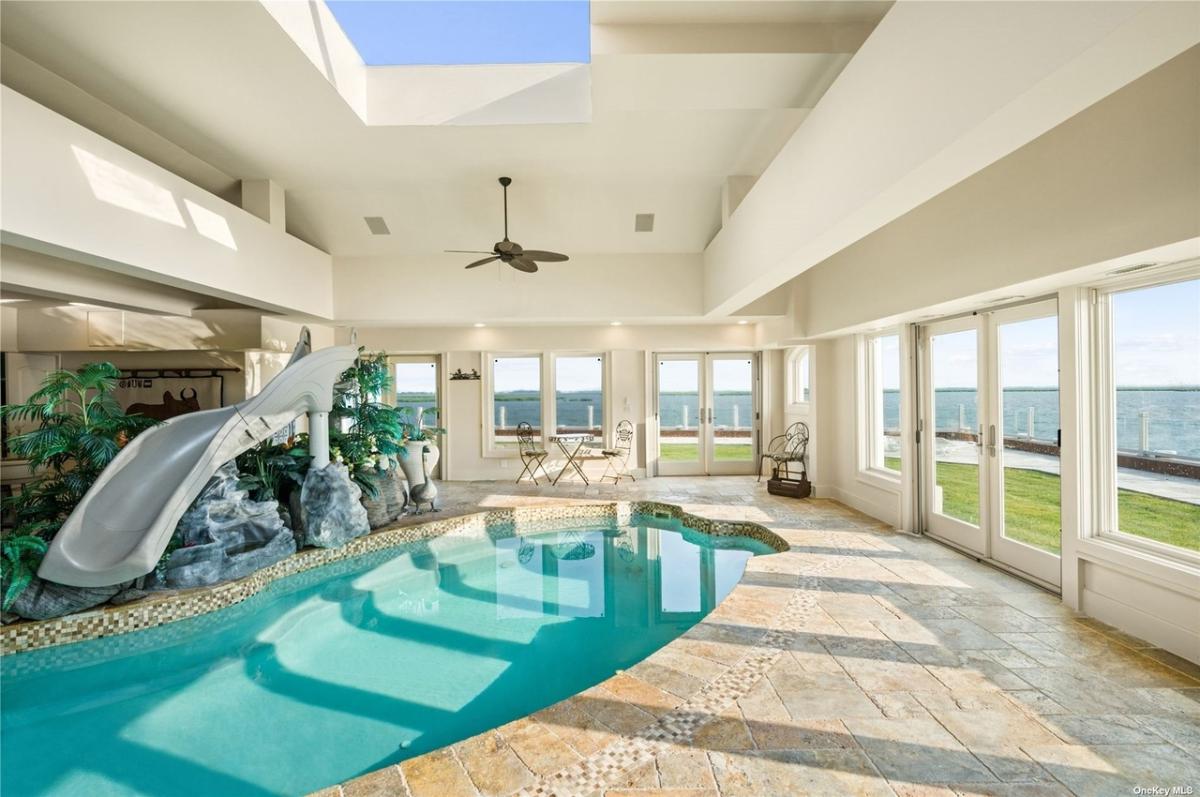 Indoor pool with glass windows and glass doors.