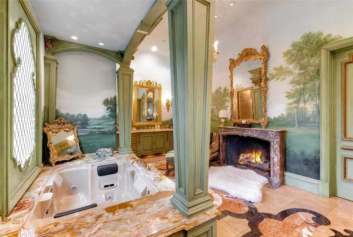 Bathroom with a soaking tub and a fireplace.