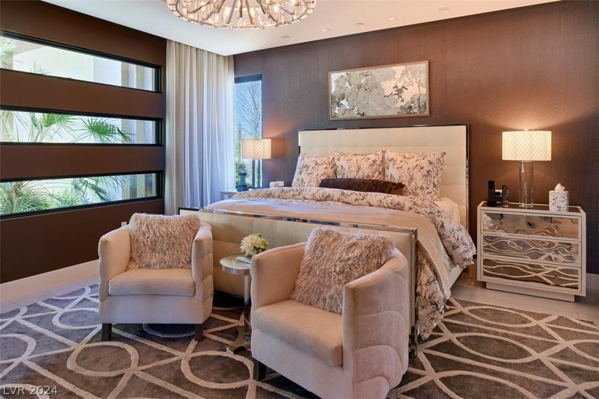 Bedroom with a chandelier and tile flooring.