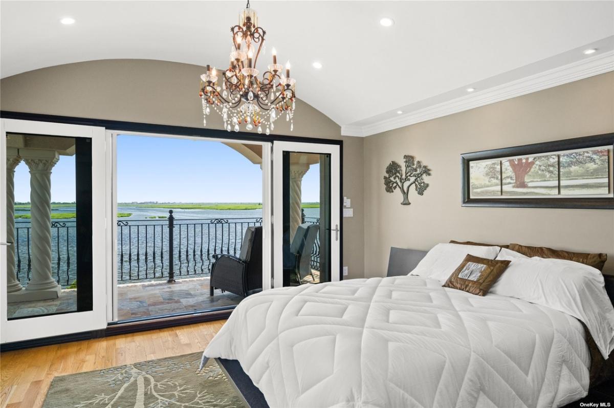Bedroom with sliding glass doors and a chandelier.