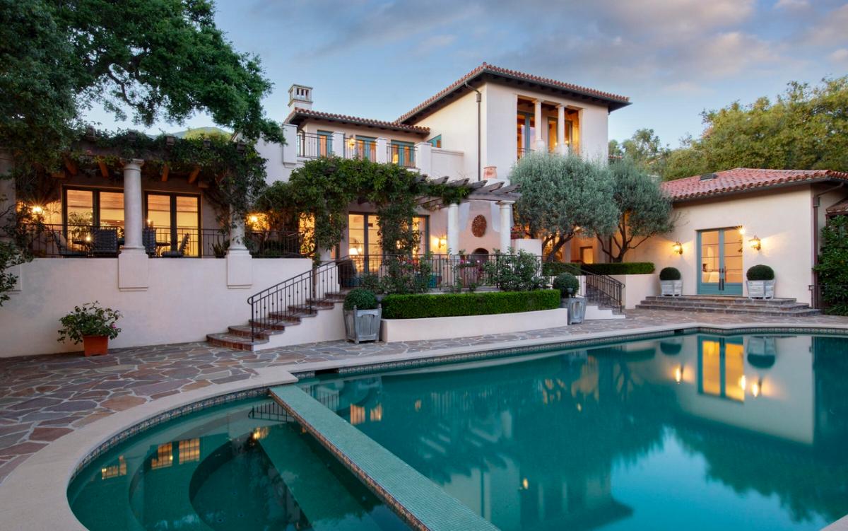 Rear view of the mansion with a pool.