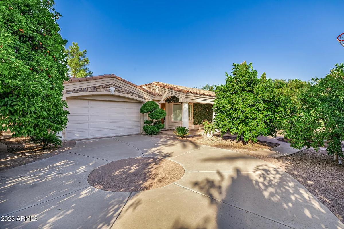 Garage with a spacious driveway.