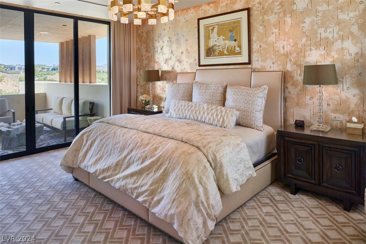 Bedroom with a chandelier and sliding glass doors.