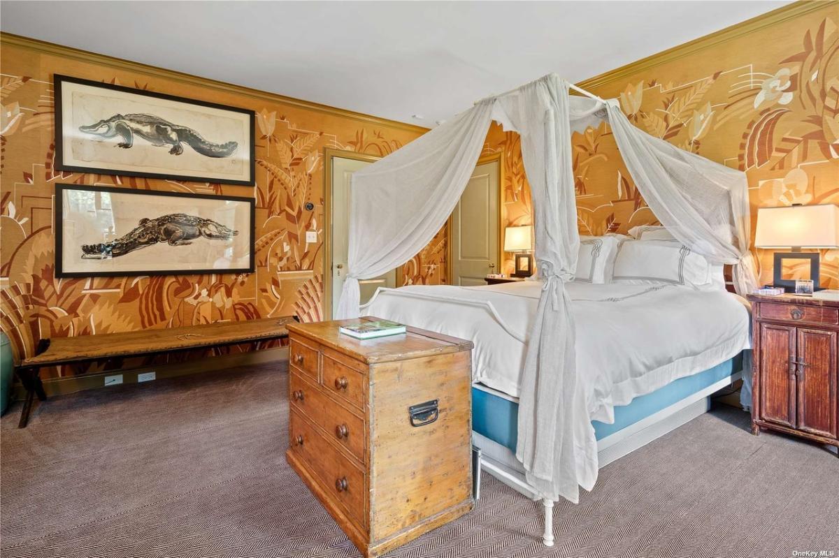 Bedroom with a large bed and carpet flooring.