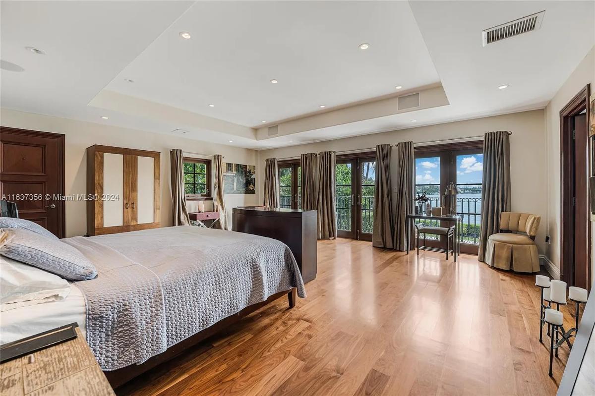 Bedroom with hardwood floors and glass doors.