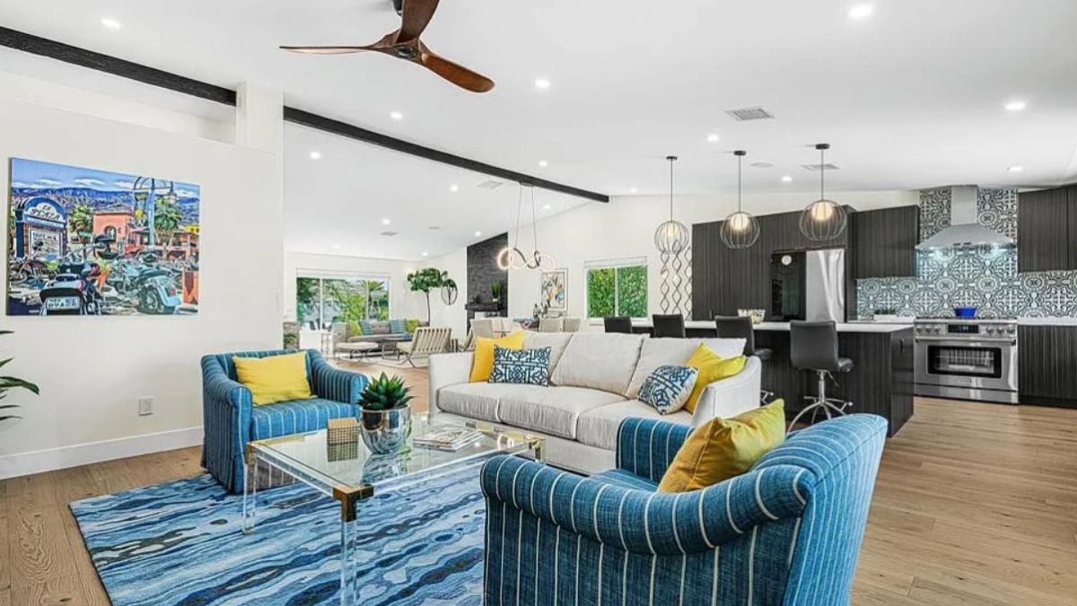 A great room with a living area, dining space, and kitchen.