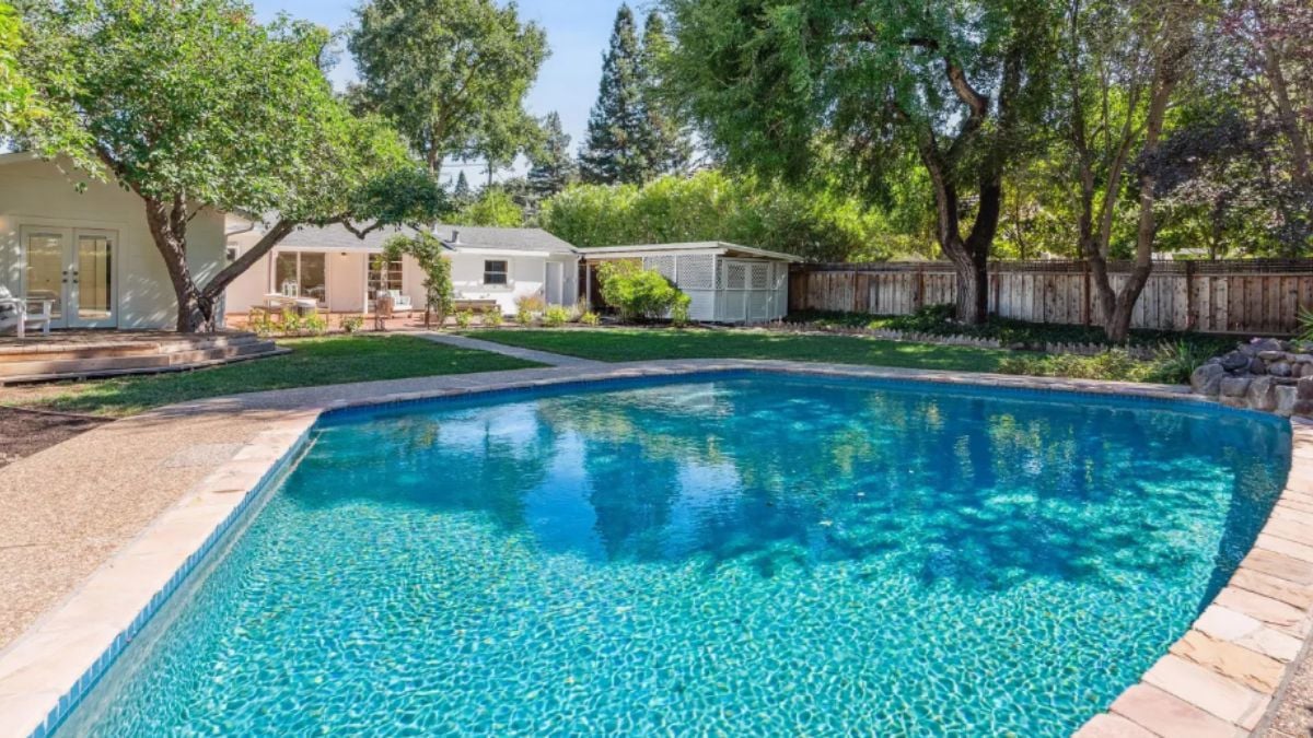 A swimming pool surrounded by trees.