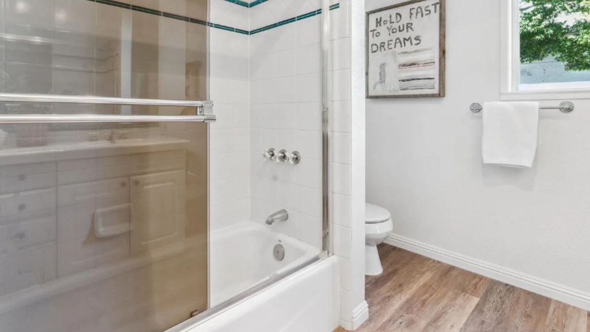 A bathroom with a bathtub and a toilet.