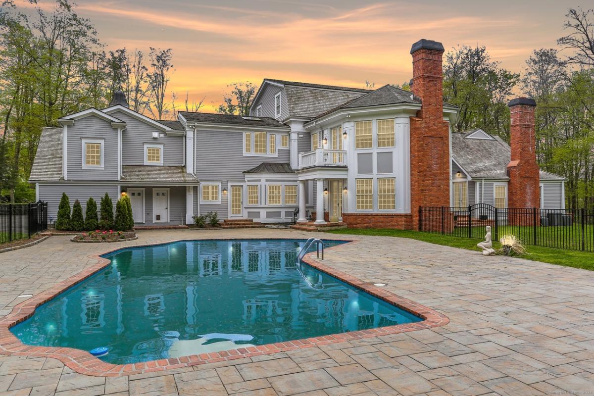 Rear view of the mansion with a pool.