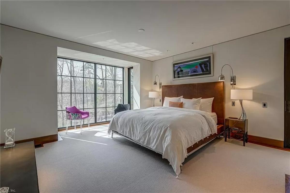 Bedroom with a large bed and carpet flooring.