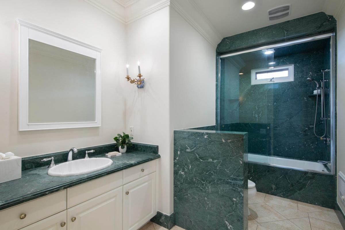 Bathroom with a sink, toilet and a walk-in shower.