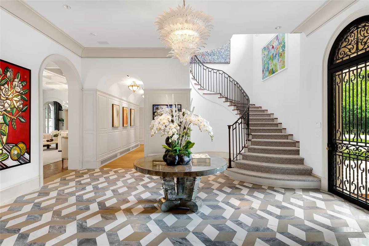 Foyer with a chandelier and stairs.