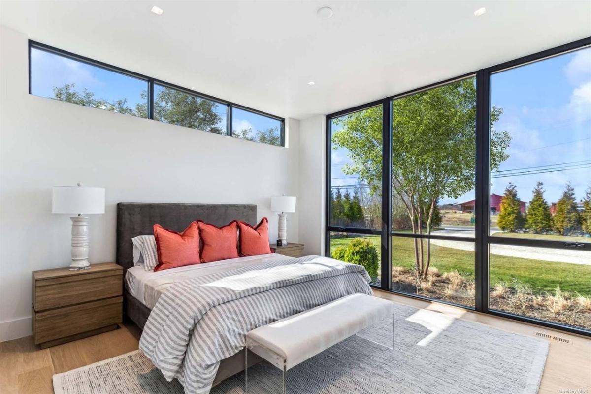 Bedroom with hardwood floors and glass walls.