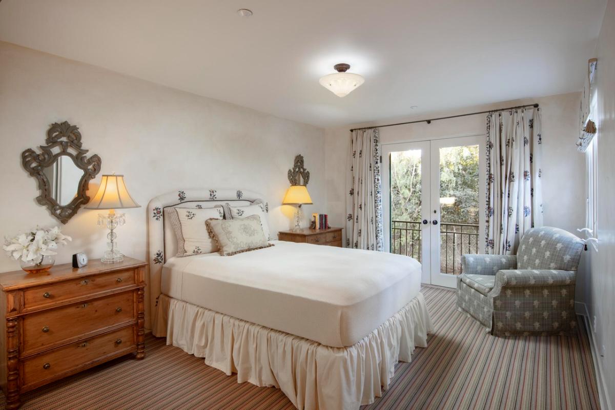 Bedroom with carpet flooring and glass doors.