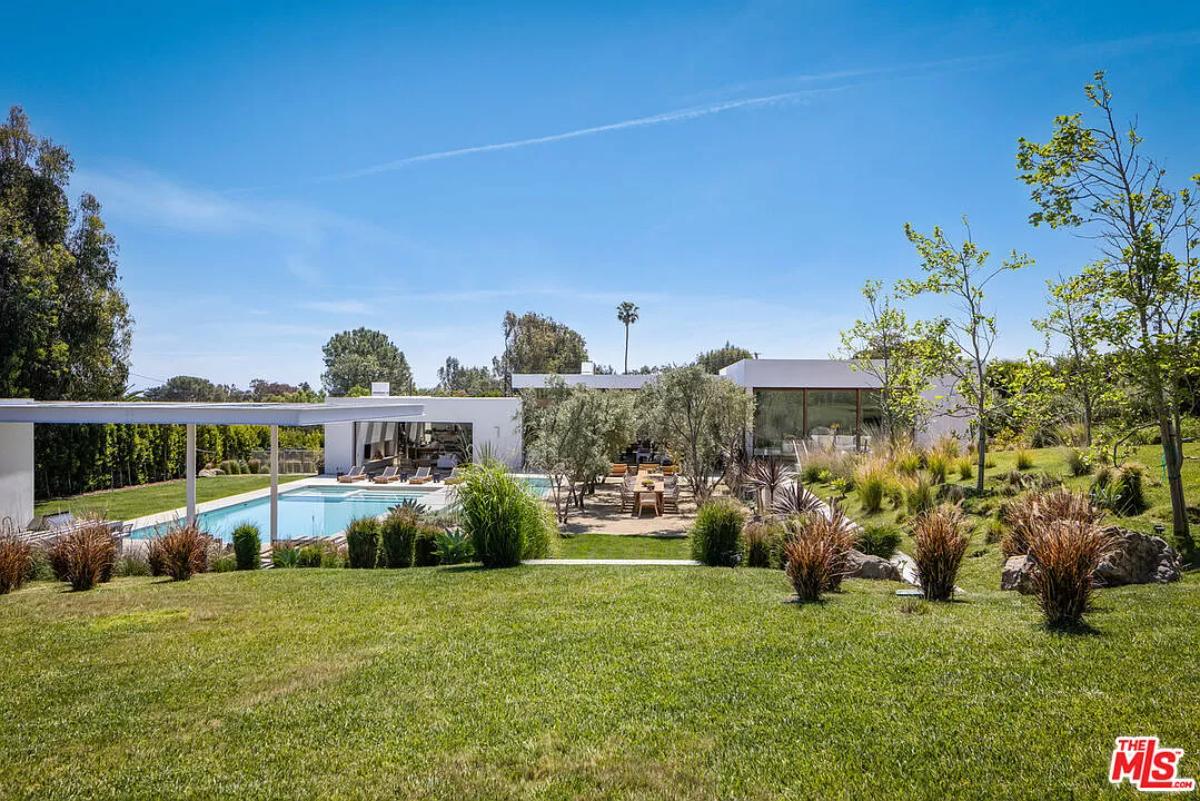 Rear view of the mansion with a pool.