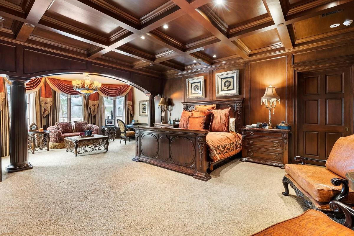 Bedroom with carpet flooring and a coffered ceiling.