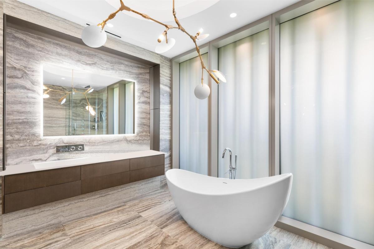Bathroom with a sink and a soaking tub.