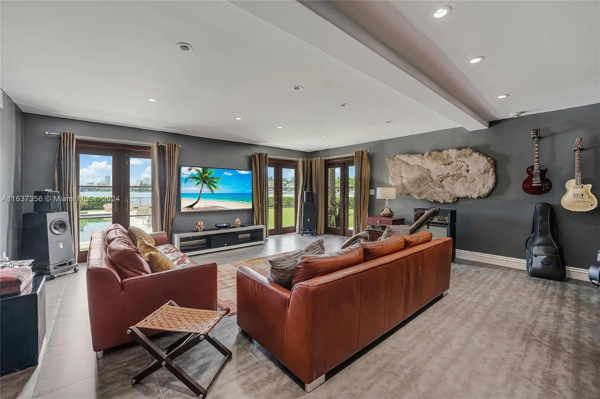 Music room with couches and glass doors.