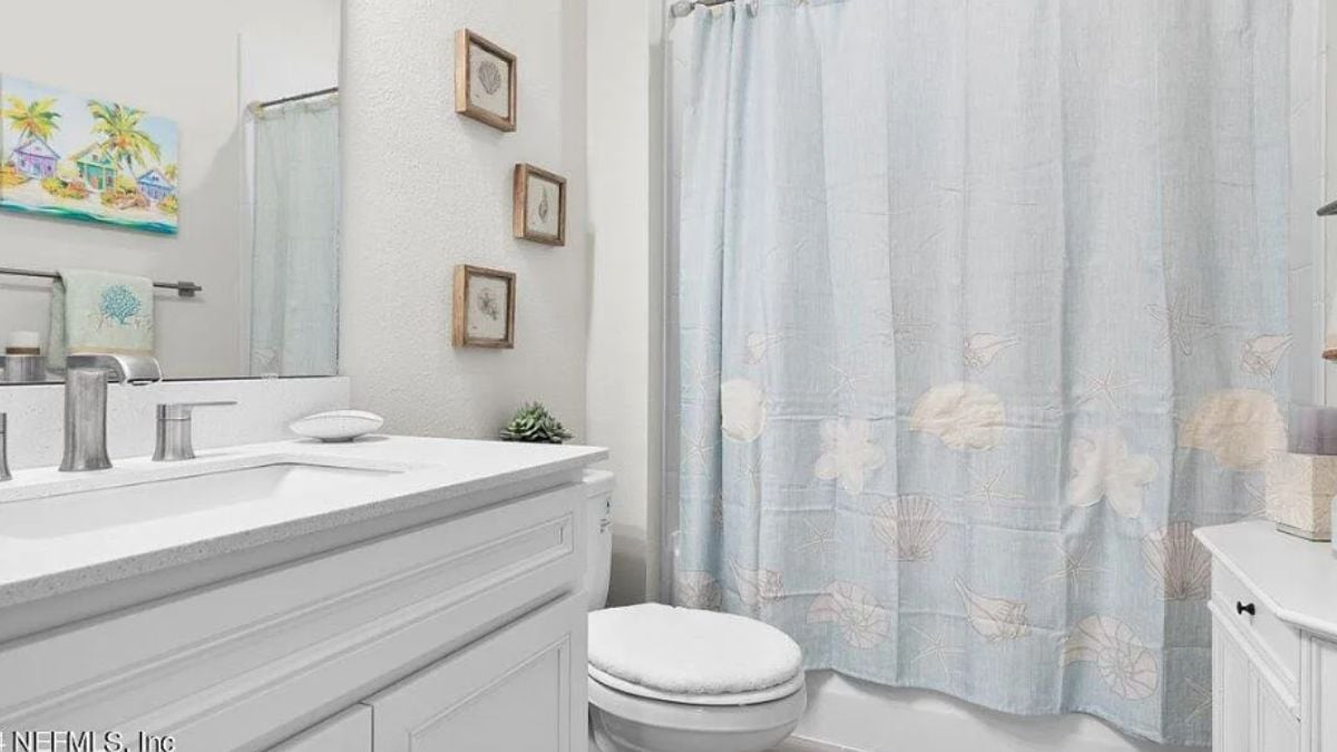 A bathroom with a vanity and a toilet.
