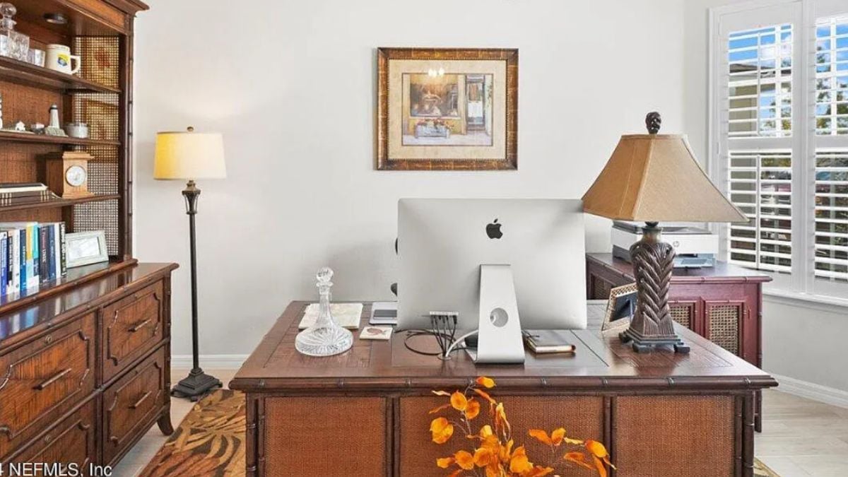 A home office with a cabinet, desk, and office chair.