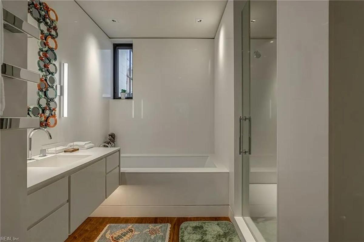 Bathroom with a sink and a soaking tub.