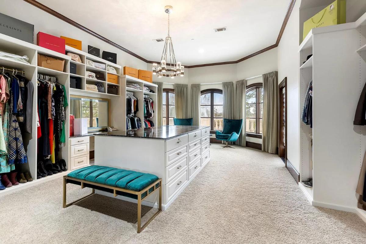 Walk-in closet with carpet flooring.
