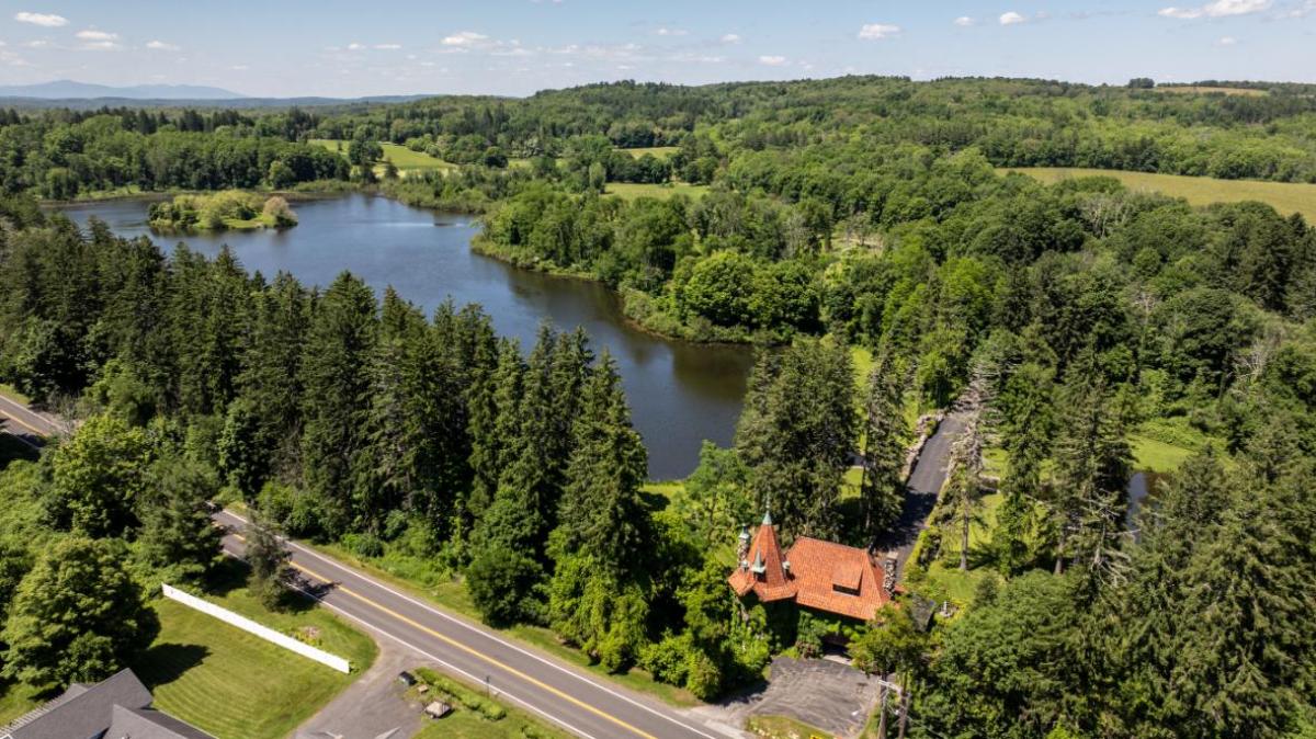 Aerial view of the property with a lake.