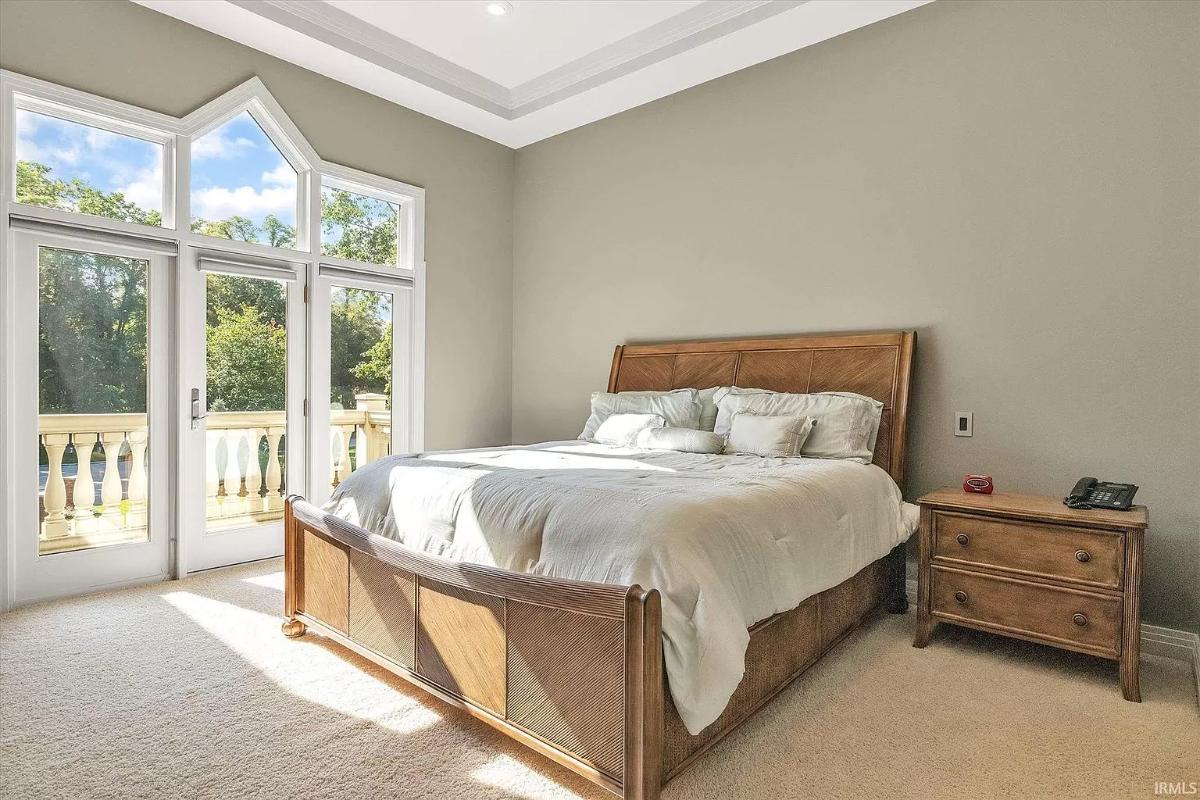 Bedroom with carpet flooring and glass doors.