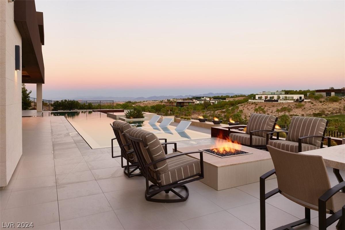 Terrace with a fire pit and a pool.