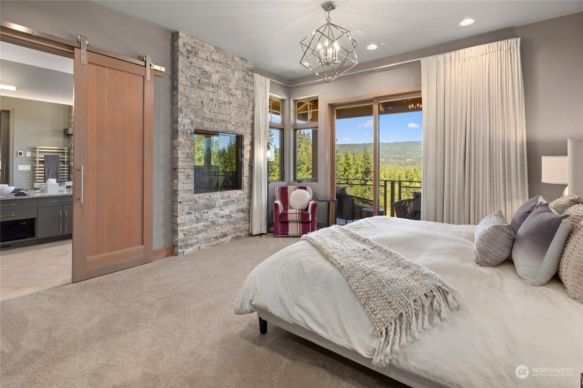 Bedroom with a large bed and carpet flooring.