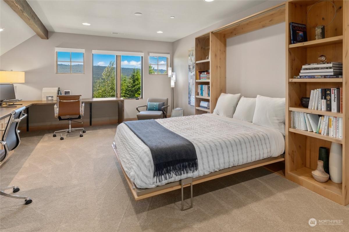 Bedroom with a large bed and carpet flooring.