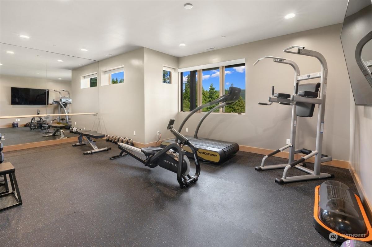 Home gym with large mirrors.