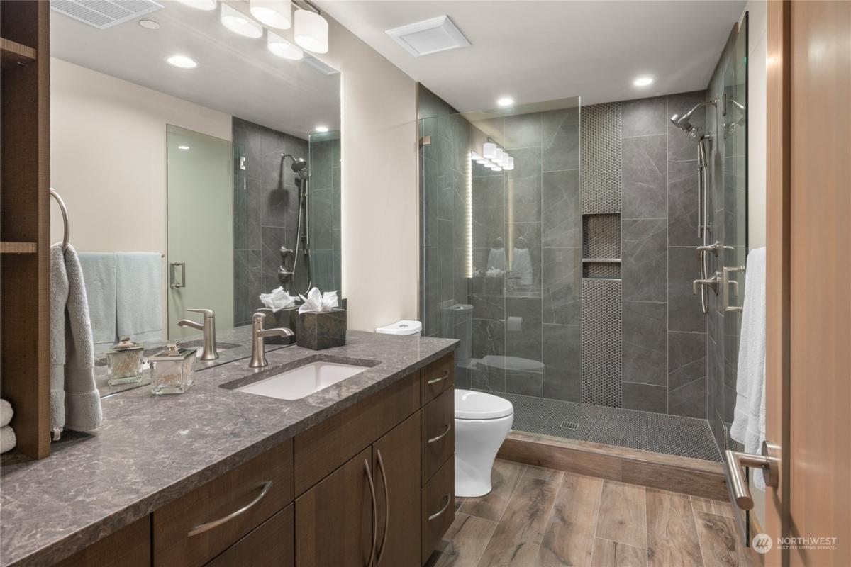 Bathroom with a sink, toilet and a walk-in shower.
