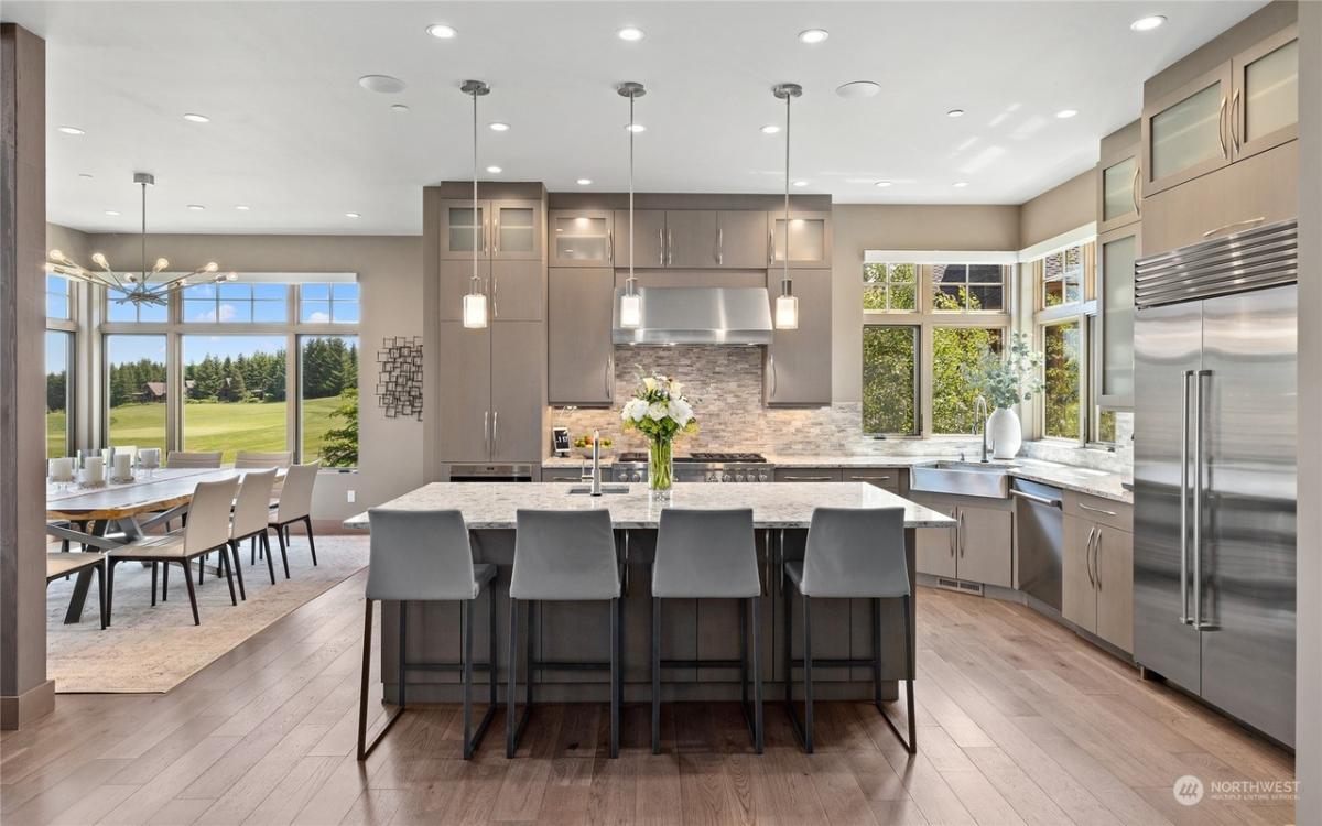 Kitchen with custom cabinetry, a counter breakfast bar and stainless-steel appliances.