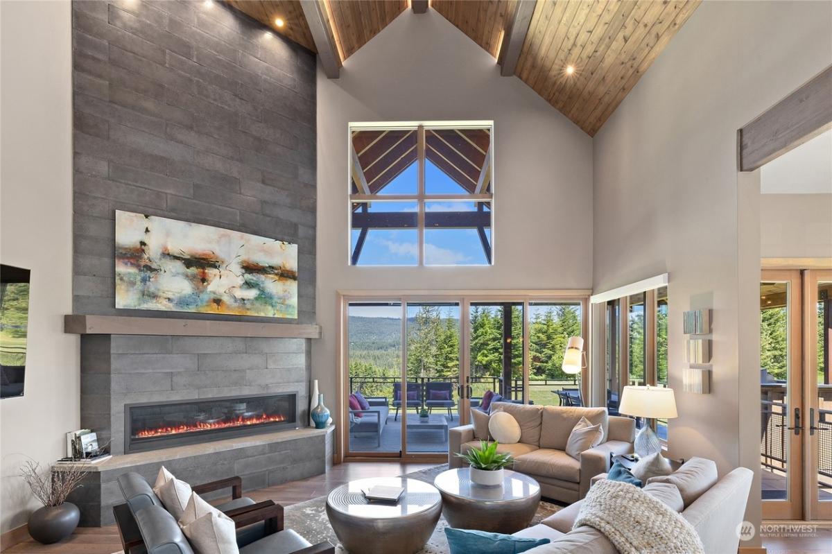 Living room with high ceilings and a fireplace.
