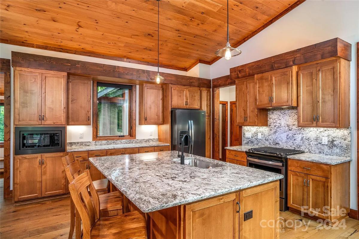 Kitchen with custom cabinetry and a counter breakfast bar.