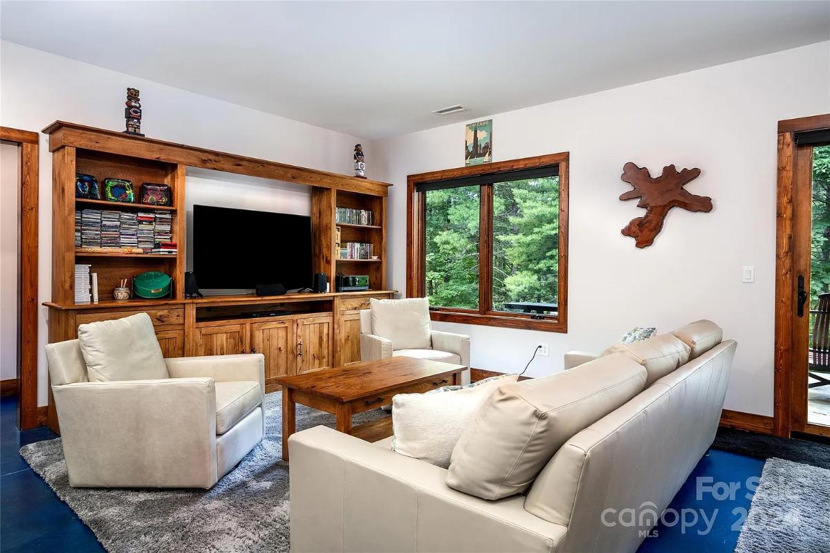 Living room with couches and a TV.