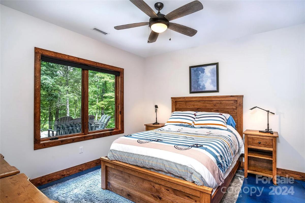 Bedroom with carpet flooring and glass windows.