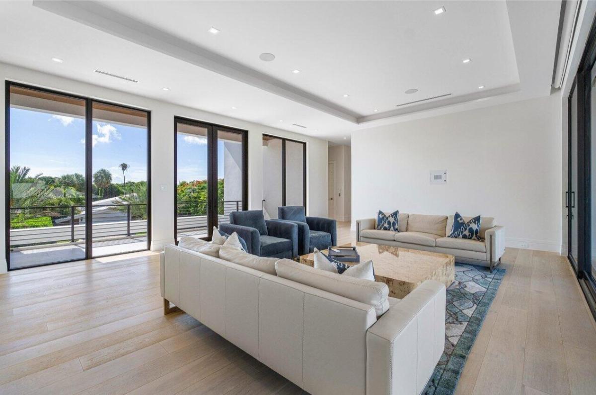 Living room with hardwood floors and custom lighting.
