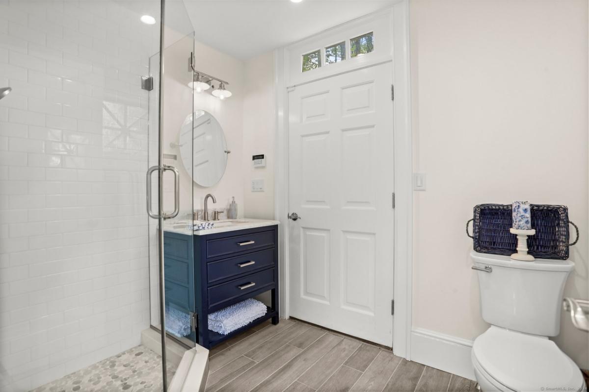 Bathroom with a sink, toilet and a walk-in shower.