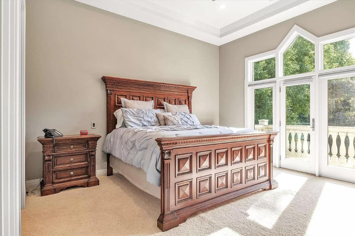 Bedroom with carpet flooring and glass doors.