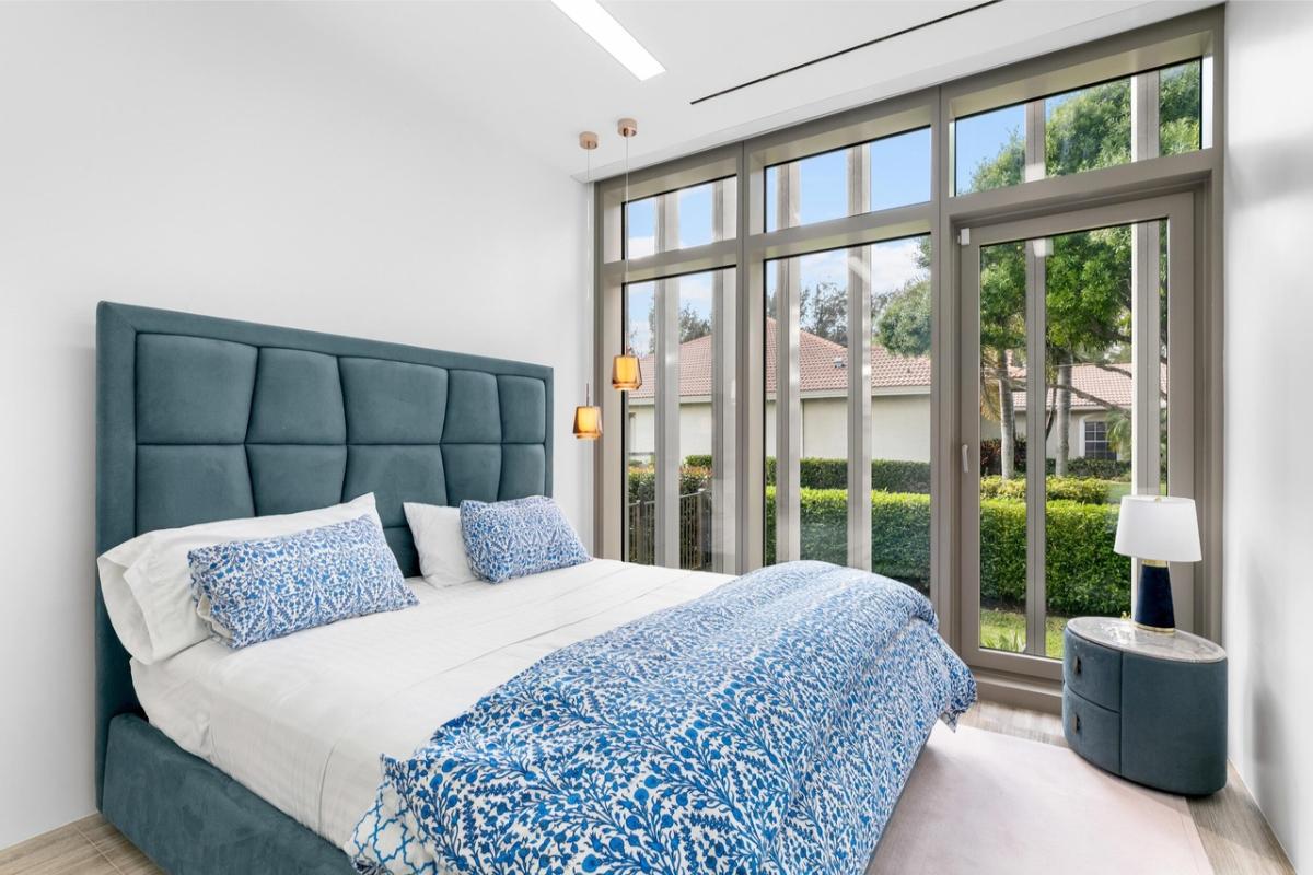 Bedroom with glass walls and a glass door.