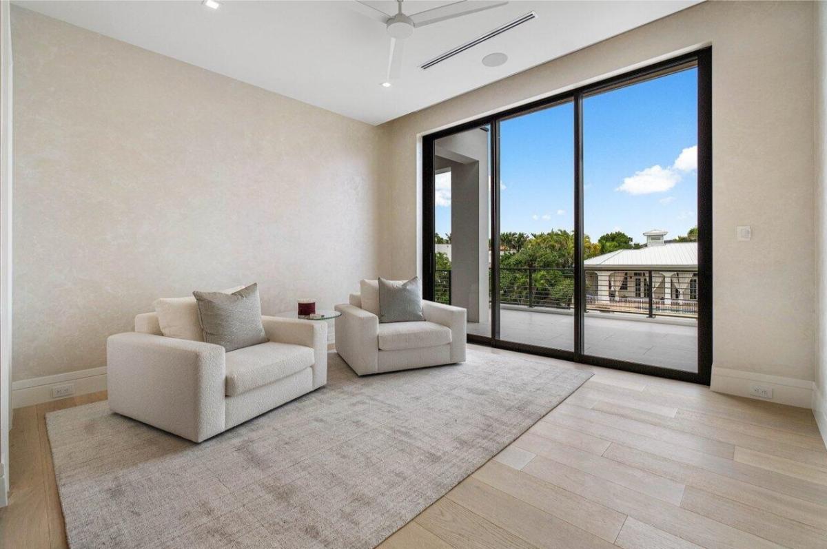 Sitting area with hardwood floors and sliding glass doors.