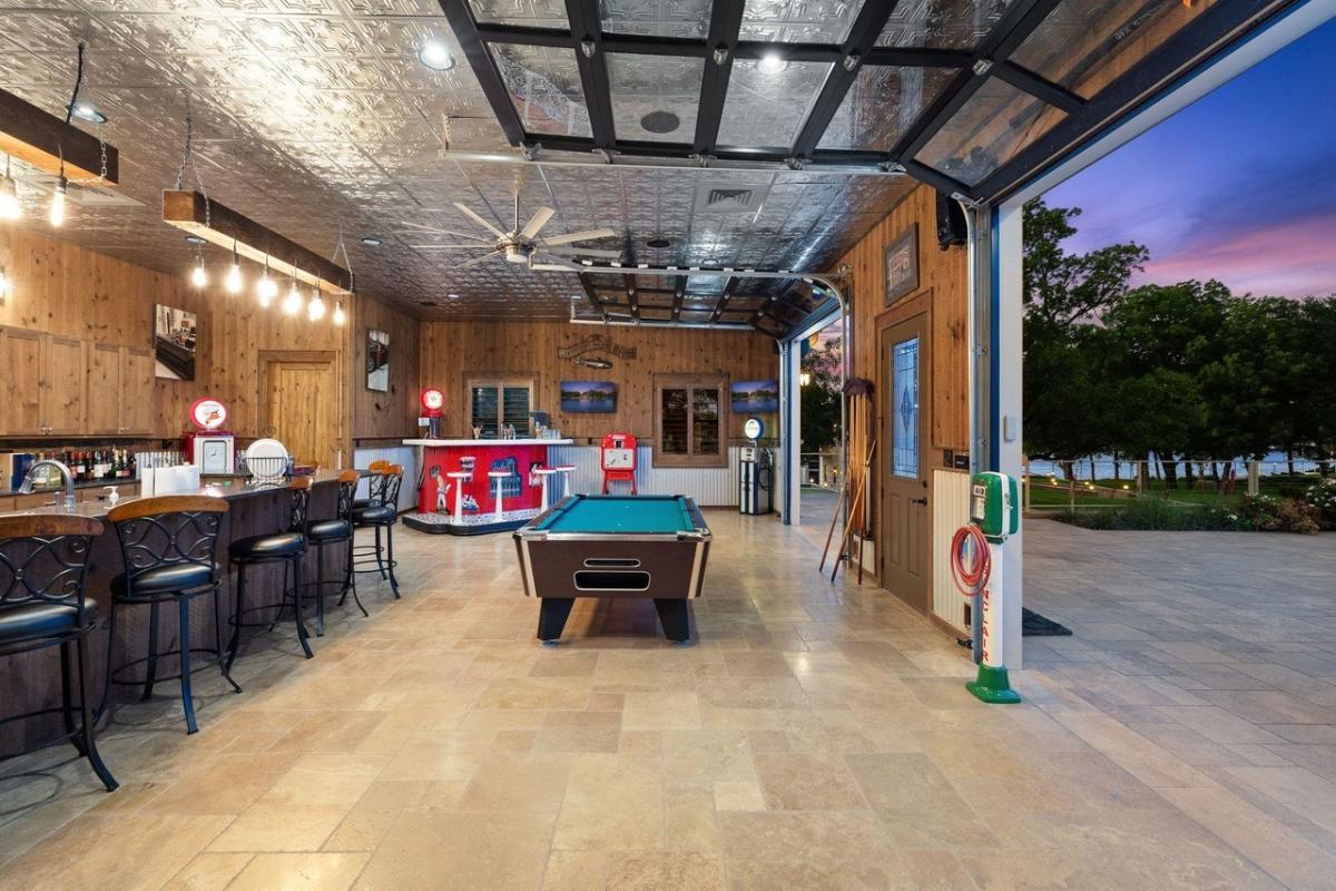 Recreational room with a bar and a billiards table.