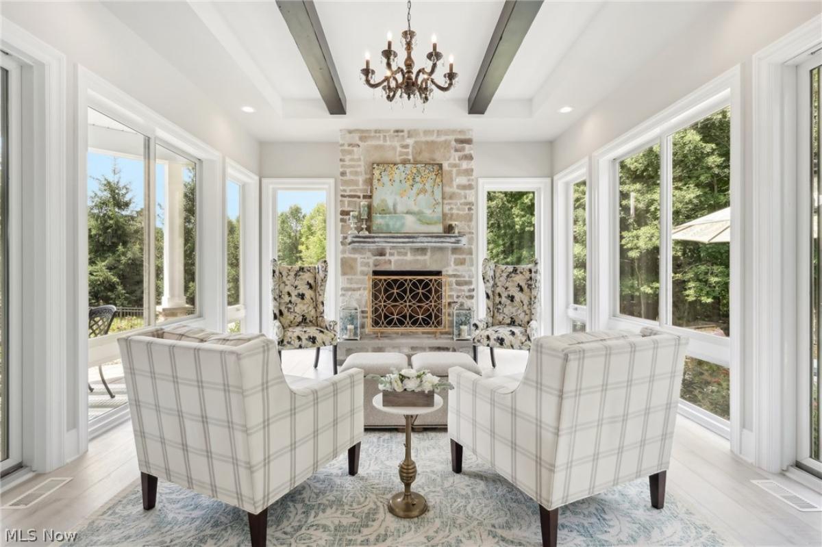 Living room with a chandelier and a fireplace.