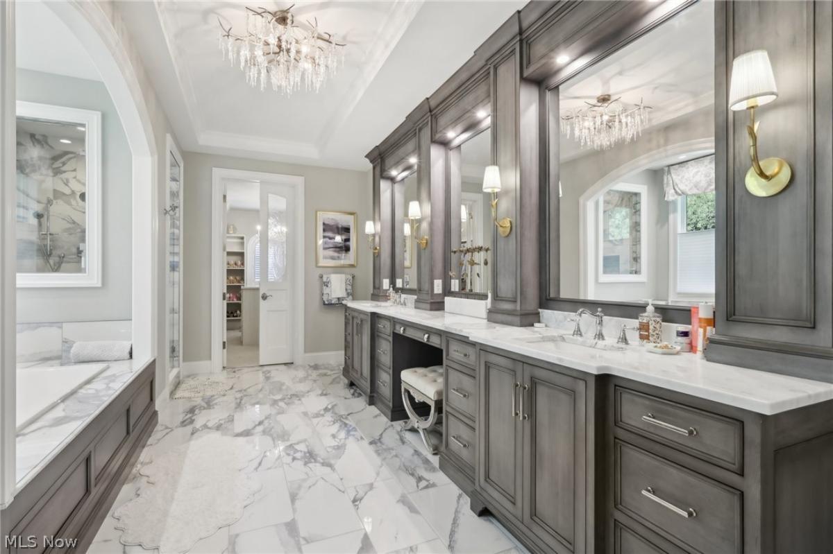 Bathroom with a custom-made vanity and a chandelier.