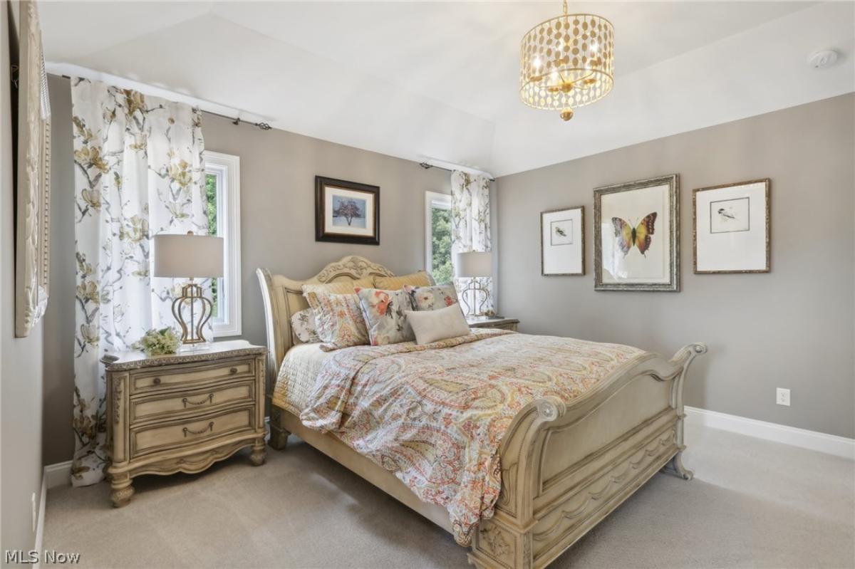 Bedroom with a large bed and carpet flooring.