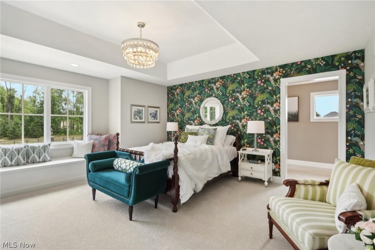 Bedroom with a large bed and carpet flooring.